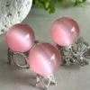 Pink cat's eye crystal sphere