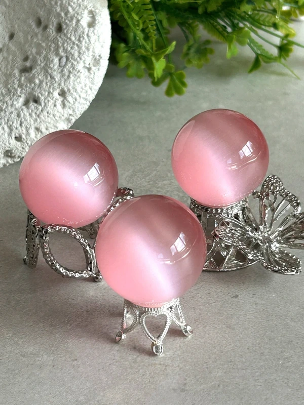 Pink cat's eye crystal sphere