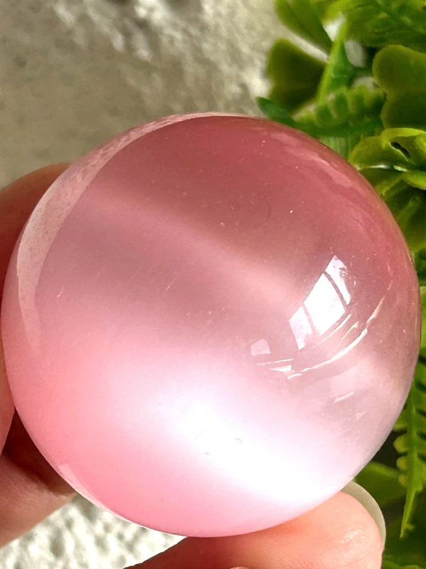 Pink cat's eye crystal sphere
