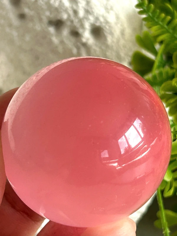 Pink cat's eye crystal sphere