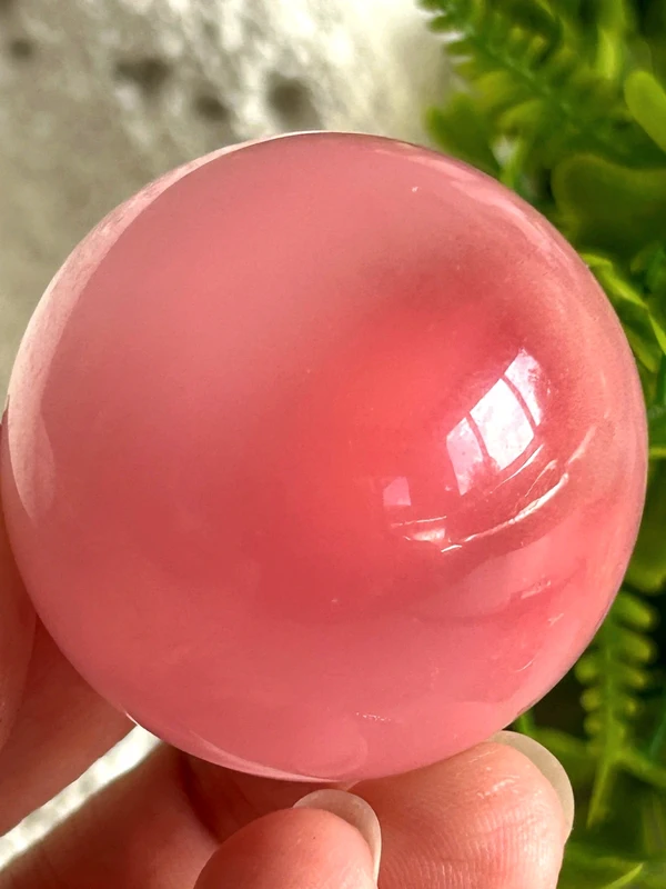 Pink cat's eye crystal sphere