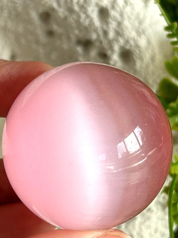 Pink cat's eye crystal sphere